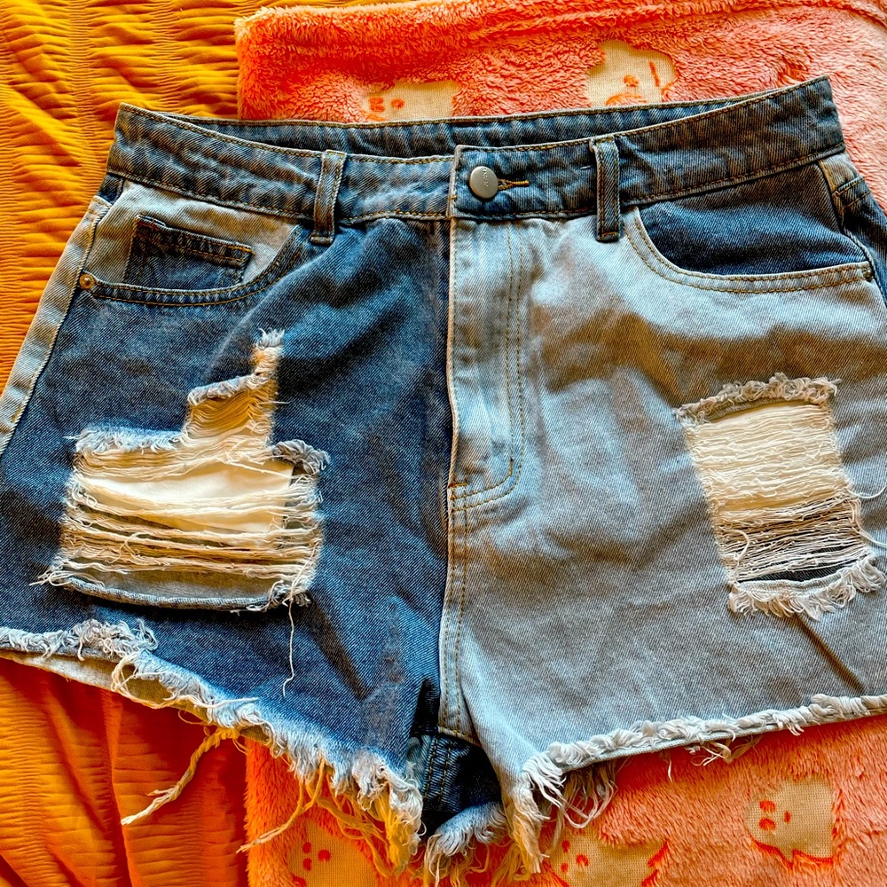 Never worn split shorts. Light and dark wash distressed denim.